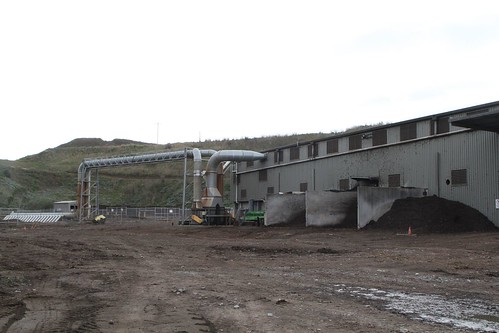 Stockpiles of compost beside the odour control filters outside the composting shed