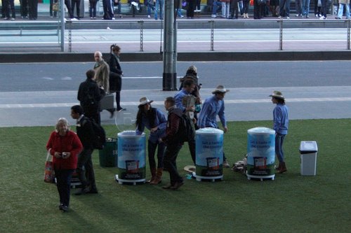 Handing out free yoghurt to tie in with Southern Cross Station being covered with yoghurt advertising