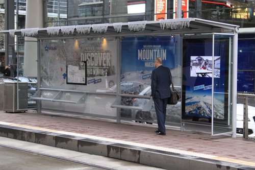 Tram stop covered in advertising for Mount Buller