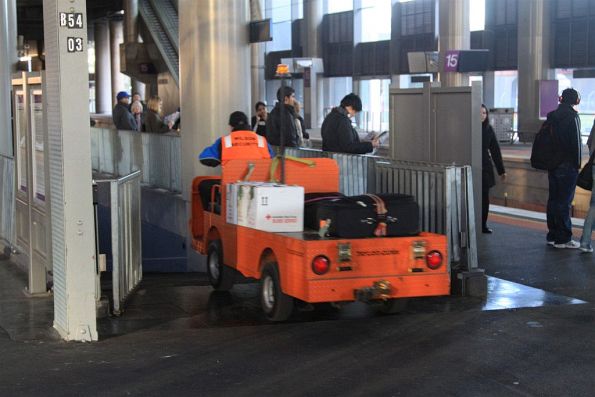 Wilson Security staff drives an electric buggy loaded with parcels and baggage into the subway from platform 14