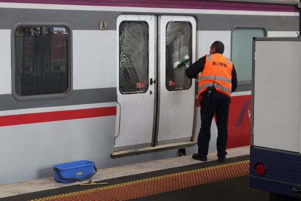 V/Line cleaning staff washing windows of a carriage set