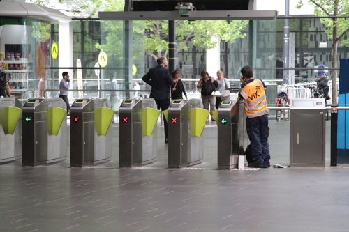 Vix technician works on a broken set of myki gates