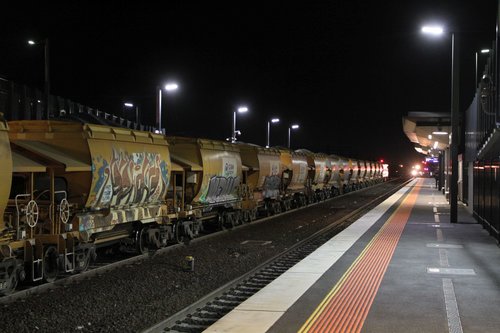 Down V/Line service arrives at Sunshine, as the up Apex train waits for a signal across to Brooklyn
