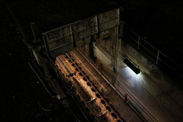Headlights shining out of the City Circle Loop portal beneath the Exhibition Street bridge